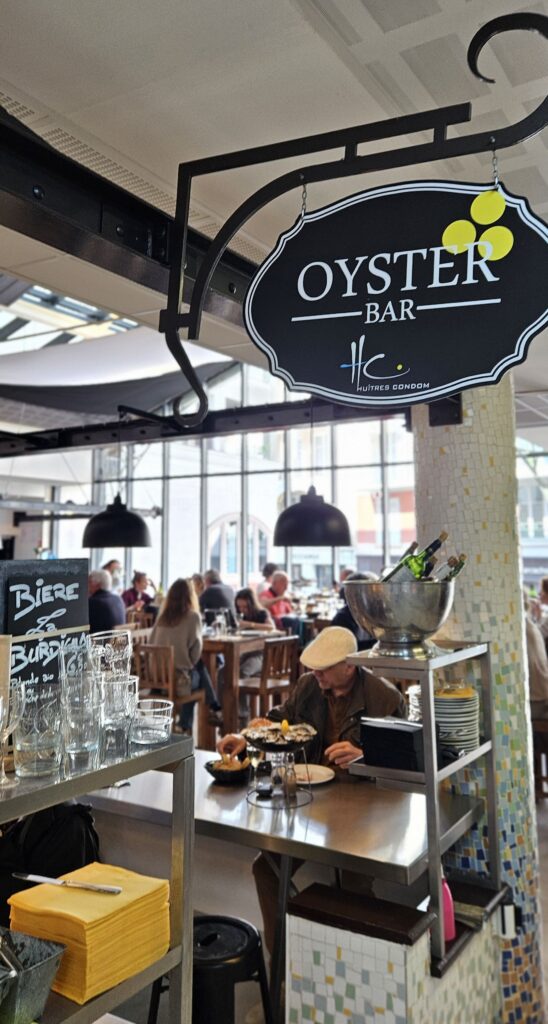 Dégustation d'huîtres à l'Oyster Bar d'Arcachon dans les halles du marché couvert.